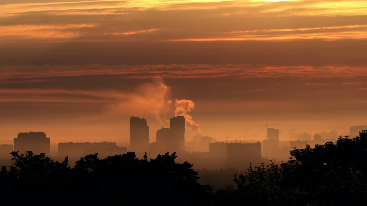 Sunrise over a city with smog and fog