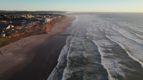 gorgeous high aerial shot of oregon coastline with beaches and crashing waves