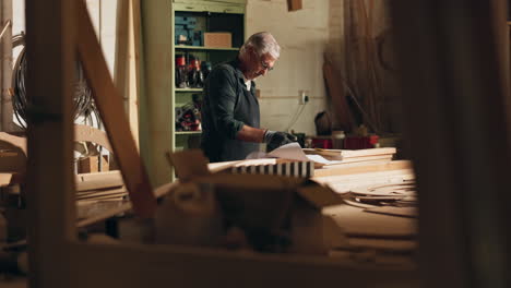 senior carpenter working in his workshop