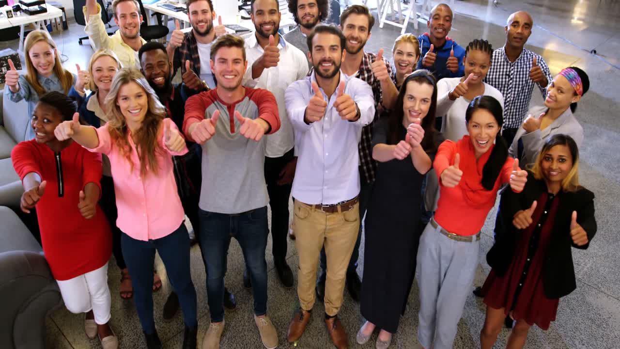 Portrait of business team gesturing together in office