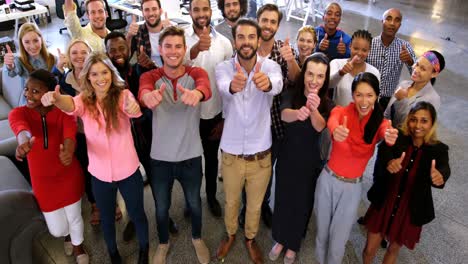 Portrait-of-business-team-gesturing-together-in-office