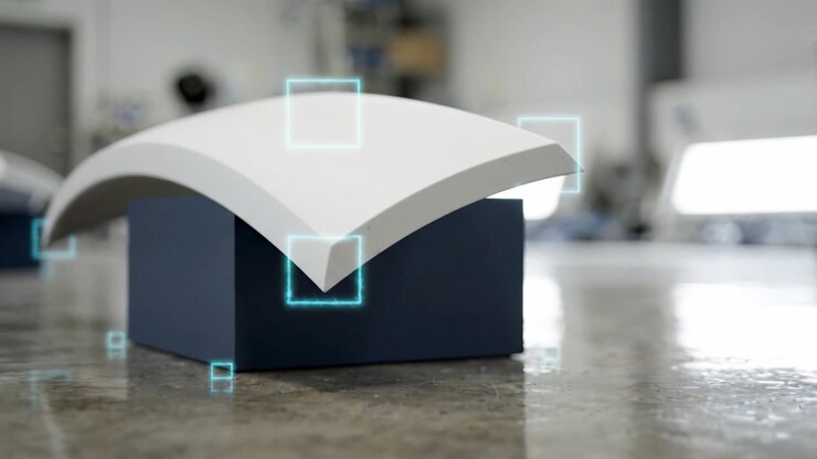 Innovative Design of a Curved Architectural Element Showcased in a Workshop, Highlighting Craftsmanship and Modern Aesthetics in a Minimalist Setting