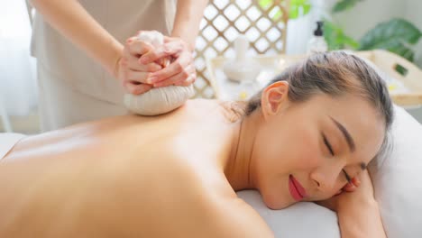 woman receiving a back massage at a spa