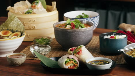 asian cuisine with spring rolls, soup, and ramen