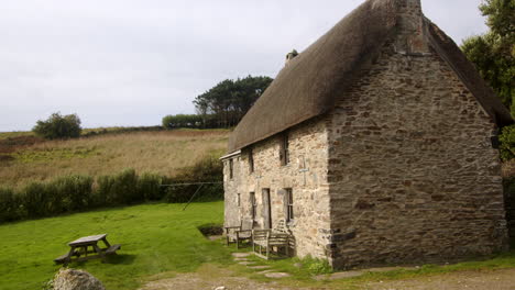 wide shots of an old stone thatch cottage at bessy's cove, the enys, cornwall