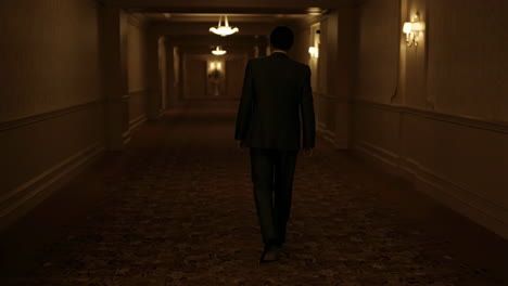 man walking down a long hallway