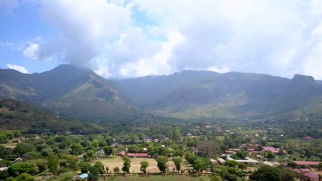moroto town with mount moroto towering in the background in uganda, africa - drone flying forward