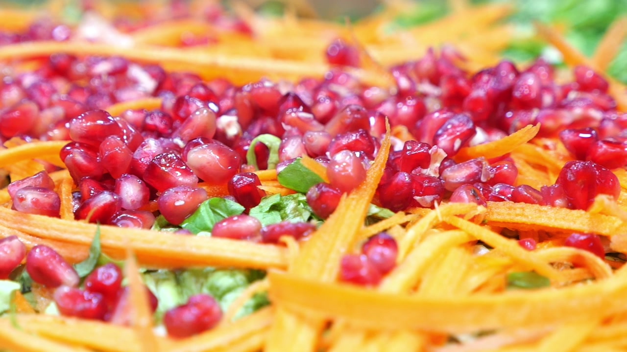 Close-up of a Vibrant Salad with Pomegranate and Shredded Carrots