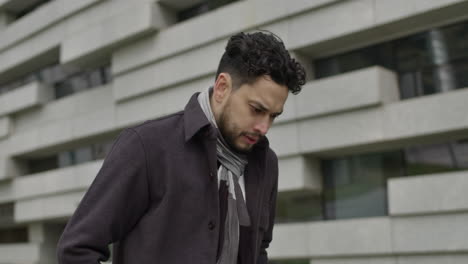 concept of handsome middle age man thoughtfully walks in downtown business district