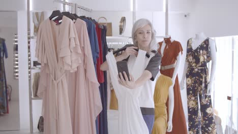 woman doing video call on smartphone in fashion store