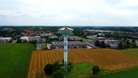 water tower in the field with green crops in the countryside