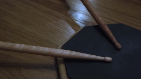 drum pad and stick on wooden surface