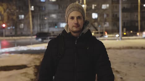 confident young handsome man in 30s walking towards camera in city streets