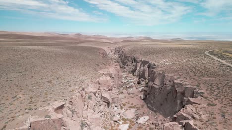 Drone-coming-out-of-a-big-canyon-in-the-Chilean-desert