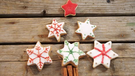 Christmas-cookies-and-cinnamon-sticks-on-wooden-table-4k