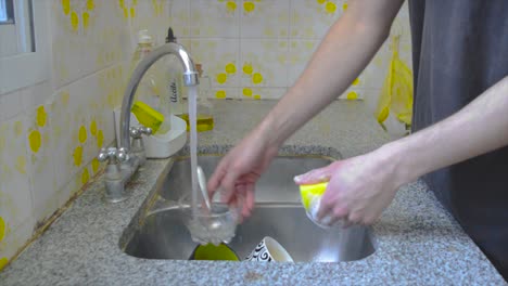 male person doing dishes at home