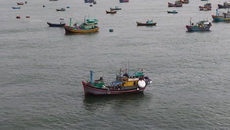 Aerial-close-up-of-fisherman-boat-in-Vietnam-Mui-Ne,-export-seafood-overfishing-concept-climate-change