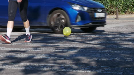 Feet-and-floating-balloon-on-crosswalk