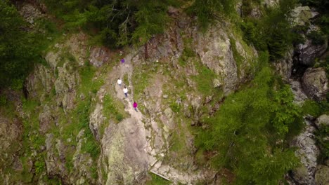 top view of a mountain: people are walking on a natural trail