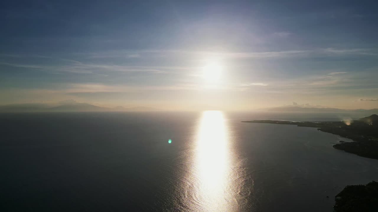 Panoramic aerial view of ocean horizon during sunset along tropical island coastline at Catanduanes, Philippines.