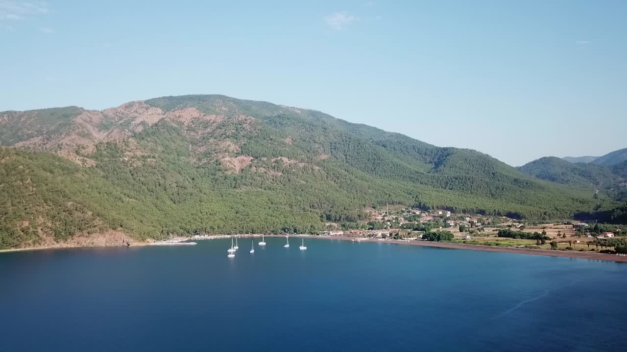 Beautiful drone view on a calm bay in Turkey with sailing boats.