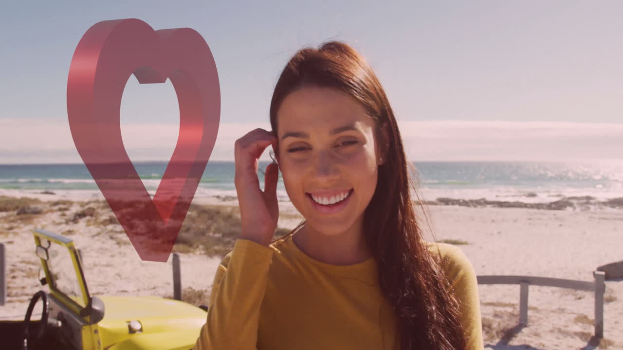 Smiling woman at beach with red heart animation over yellow vehicle