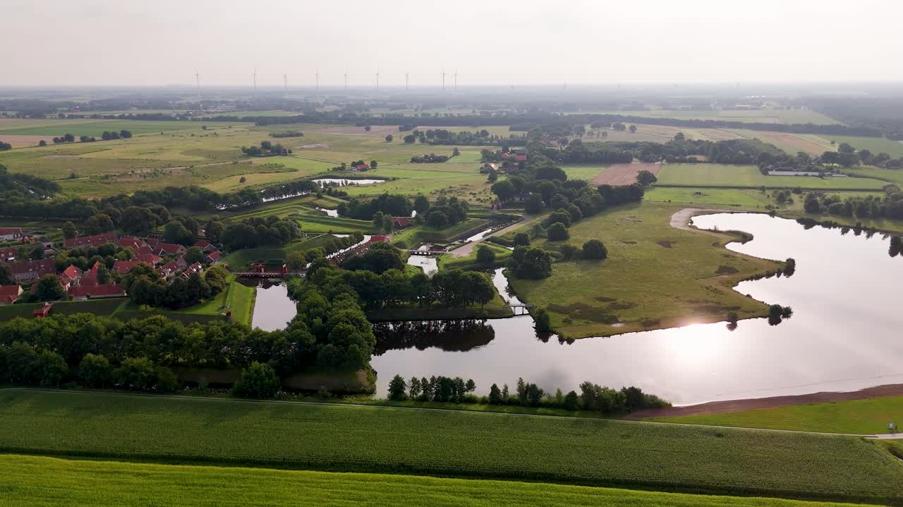 Aerial View of a Historic Fortified Town and Rural Landscape with Wind Turbines