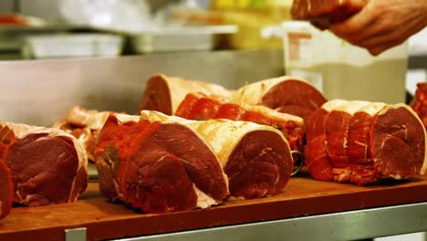 butcher slicing meat with knife