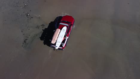 following a red lifeguard truck from the air driving through a puddle