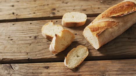 video of baguette with four slices on a wooden surface