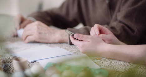 old man retirement smiling senior man talking with granddaughter while using digital tablet