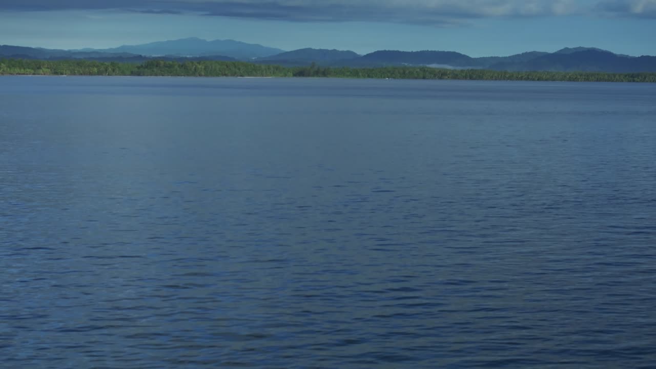 Wewak sea harbour view Wewak Hill Cape Wom Dogreto aerial drone Papua New Guinea Pacific Ocean pristine remote tropical jungle untouched beach coastline sunny dry season blue sky morning forward pan