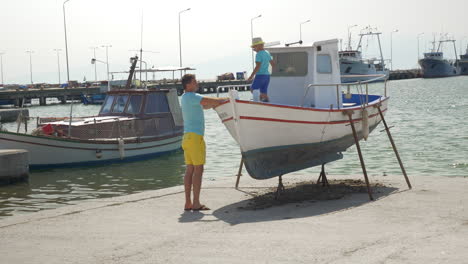 father and son on the docks with boats