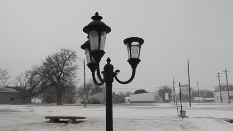 vintage looking light post and bulbs in a quiet park in a small, midwest town in kansas on a cold winter day in december during christmas time