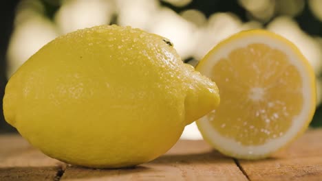 lemons on wooden table, water drop falling of fresh lemon, bokeh background