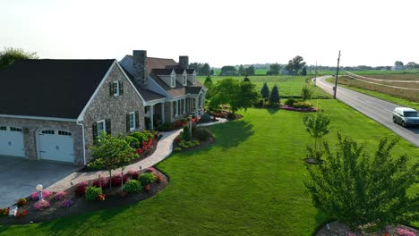 american home with beautiful landscaping in summer