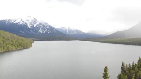 4K-done-footage-flying-over-lake-in-snowy-weather