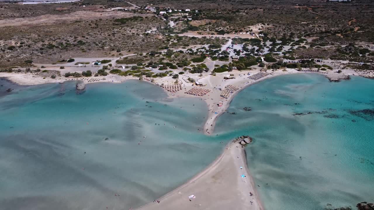 분홍색 모래로 해안을 둘러싸고 있는 얕은 바다가 있는 크레타 섬의 엘라포니시 해변