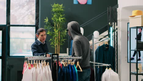 Robber-trying-to-sneak-stolen-shirt