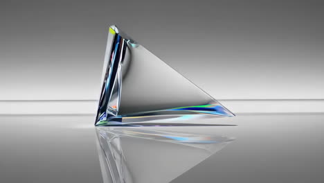triangular crystal prism with light refraction on a reflective surface