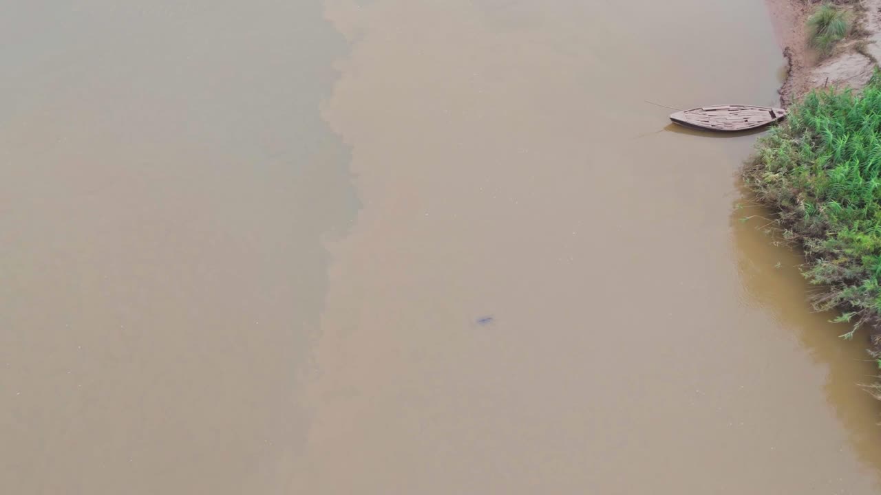 wooden boat in the banks of river