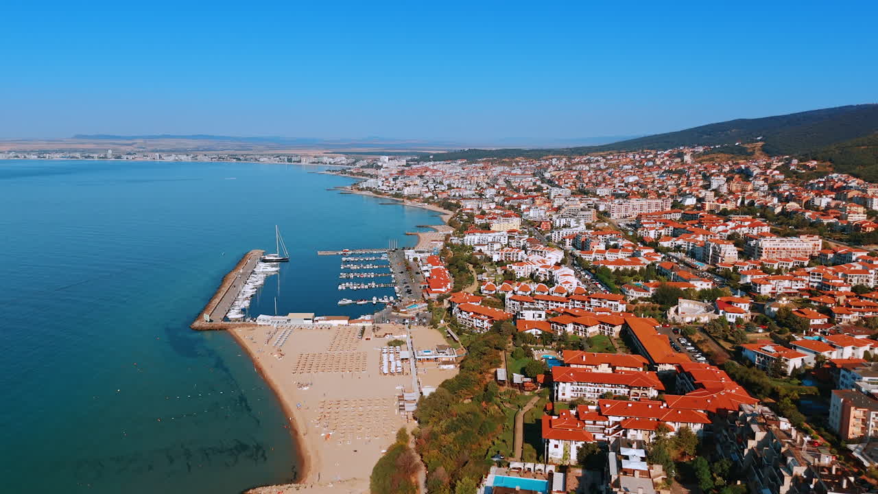 Sunny shore of the Black Sea resort. Aerial perspective on the beach, yacht club and multiple hotels in Sveti Vlas, Bulgaria