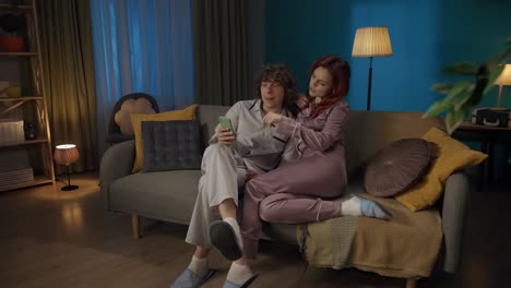 couple watching something funny on a phone