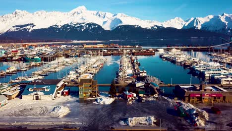 4K-Drone-Video-of-Seward-Boat-Harbor-and-Surrounding-Snow-Covered-Mountains-on-Snowy-Winter-Day-in-Alaska