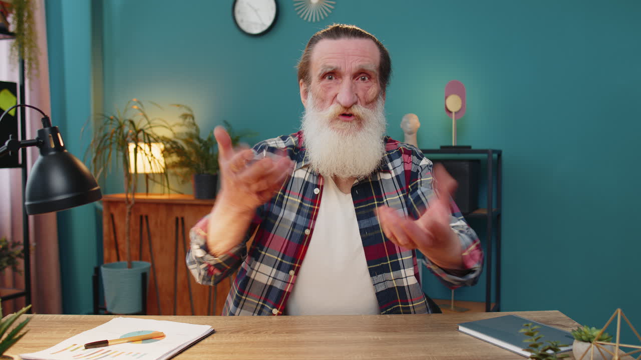 Conflict quarrel negotiation angry elderly man engaged in webcam online video call at home office