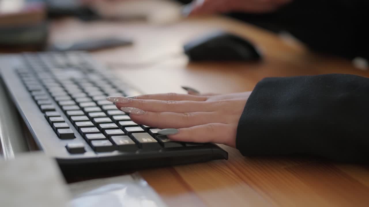 Close-up of a person's hands typing on a computer keyboard, showcasing a focus on productivity and technology in the workplace