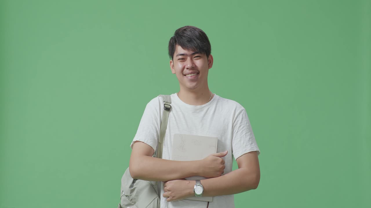 배 과 책 을 들고 미소 짓는 학생