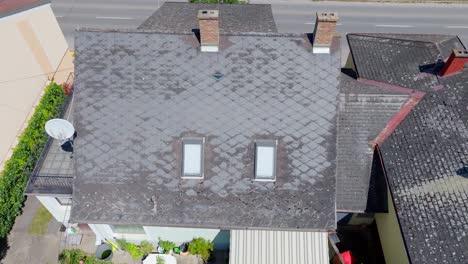 aerial view of worn gray eternit roof tile of a house