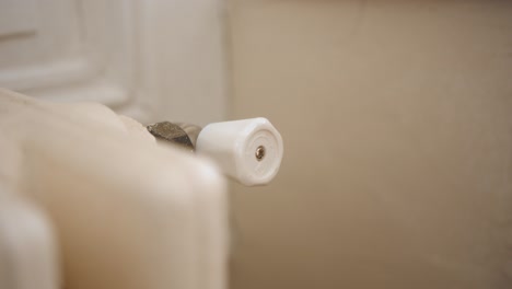 A-Hand-Twisting-the-Knob-of-a-Towel-Rack---Close-Up