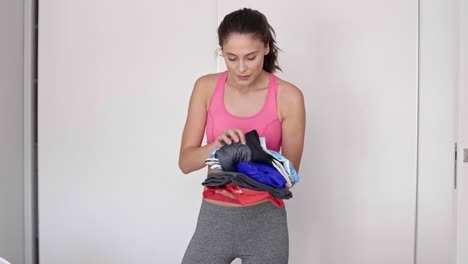 woman preparing gym bag at home